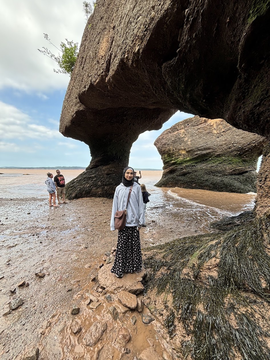 girl standing on a rock during low tide