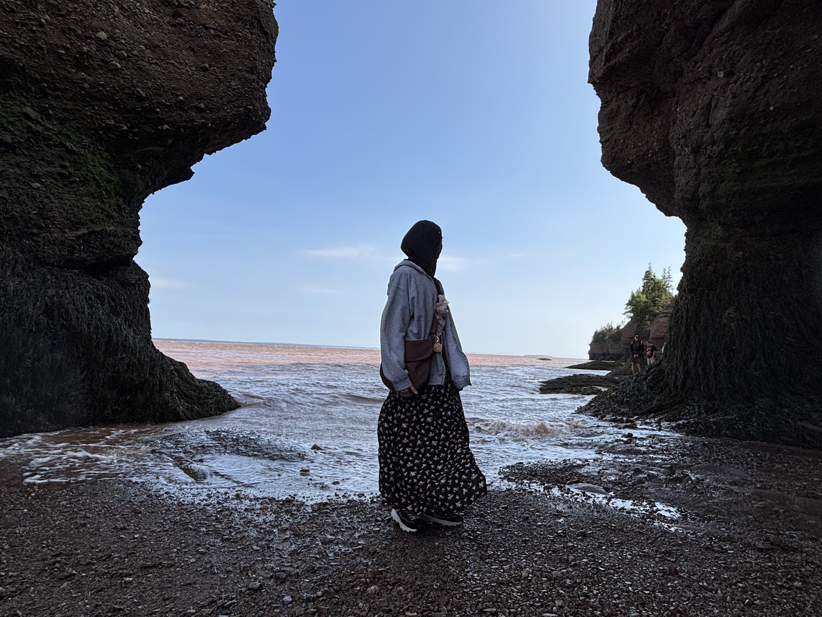girl looking out at water during low tide